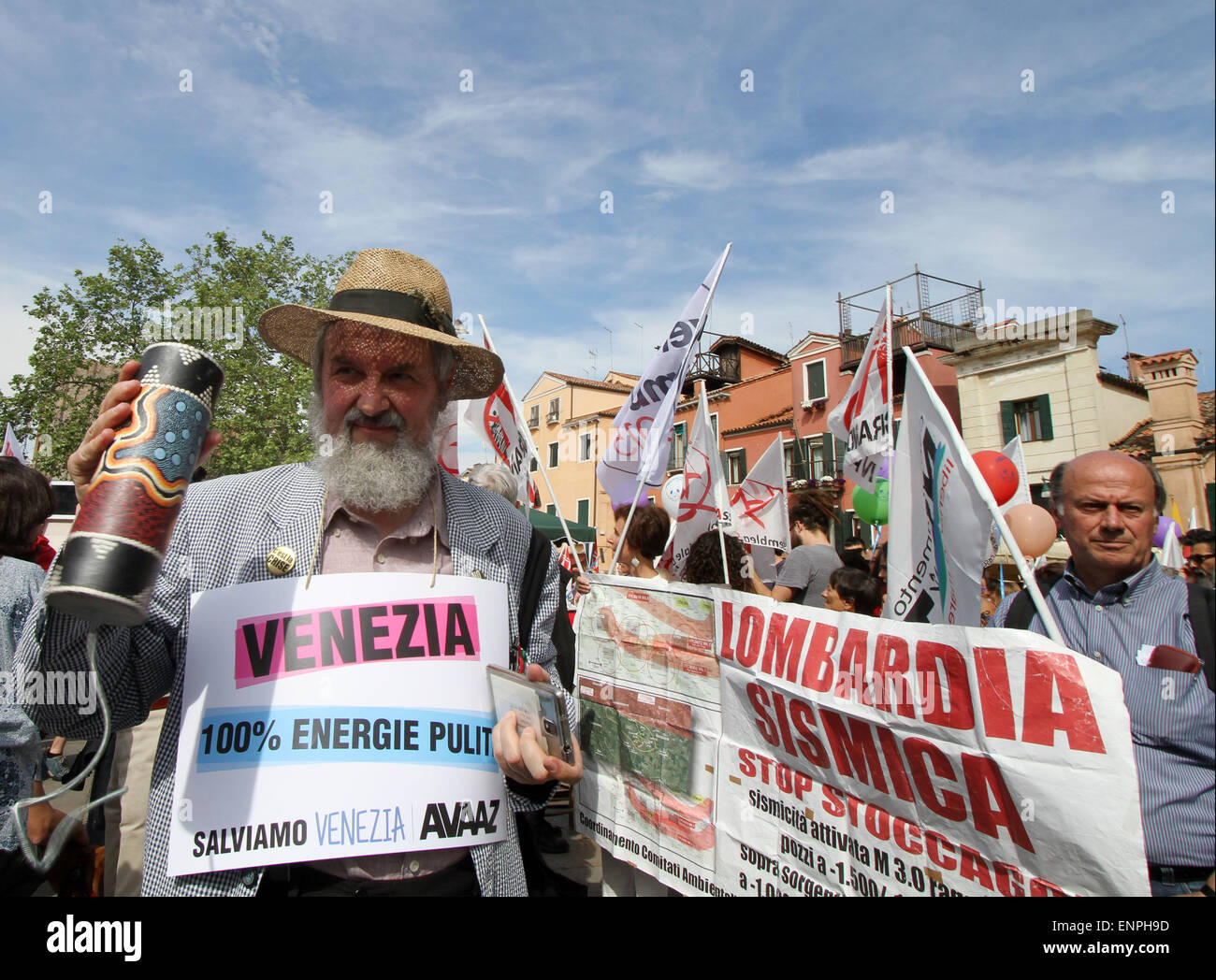 Venice, ITALY: A man holds a poster with the words Venice 100% clean energy during the protest by activists of "No Big Ships" ('No Grandi Navi') in Venice on 9 May 2015. Stock Photo