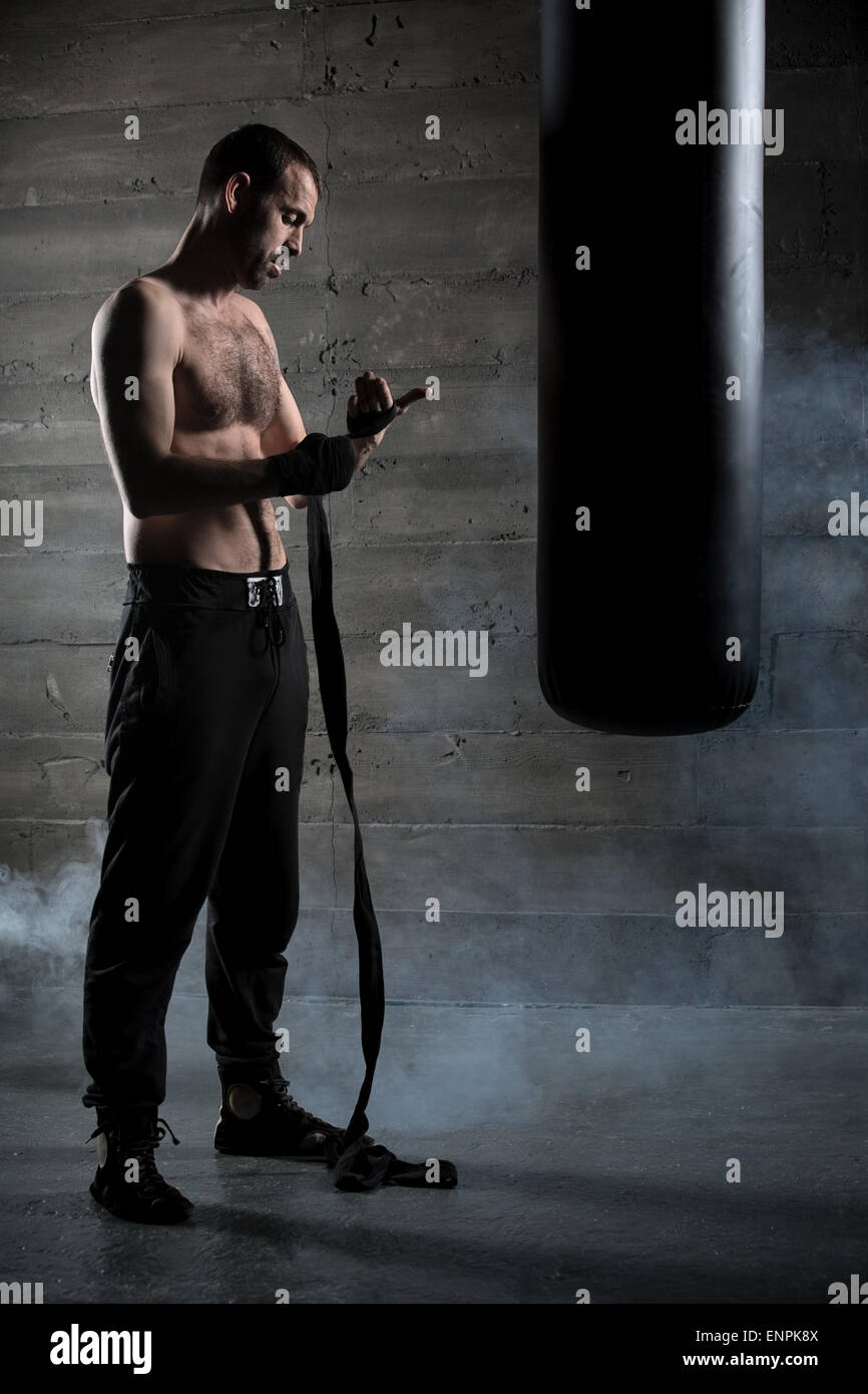 Boxer pulls bandages for boxing Stock Photo