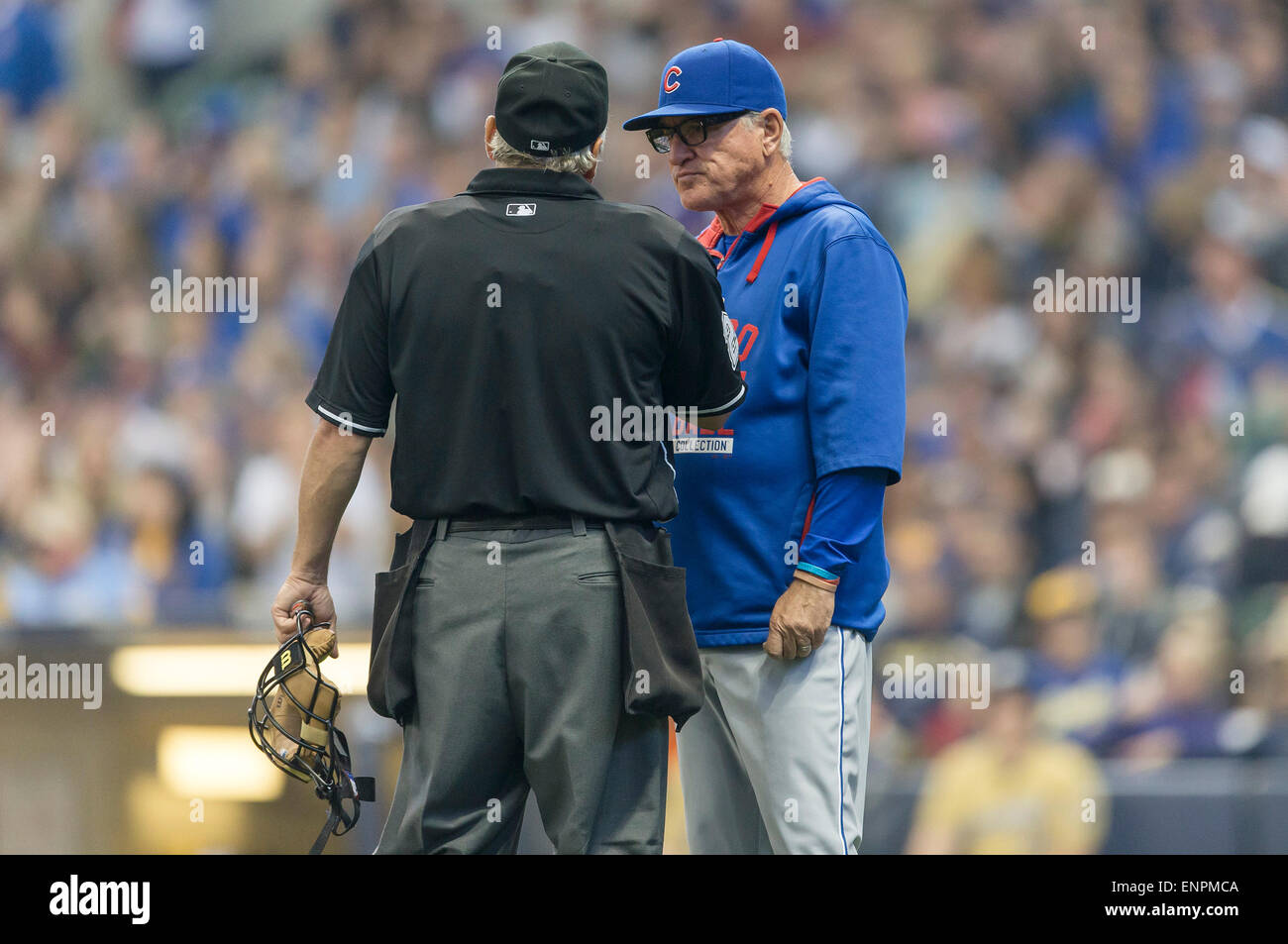 Milwaukee, WI, USA. 9th May, 2015. Chicago Cubs manager Joe Maddon #70 talks with home plate umpire Tom Hallion about a ball that was called trapped at the bottom of the outfield fence during the Major League Baseball game between the Milwaukee Brewers and the Chicago Cubs at Miller Park in Milwaukee, WI. John Fisher/CSM/Alamy Live News Stock Photo
