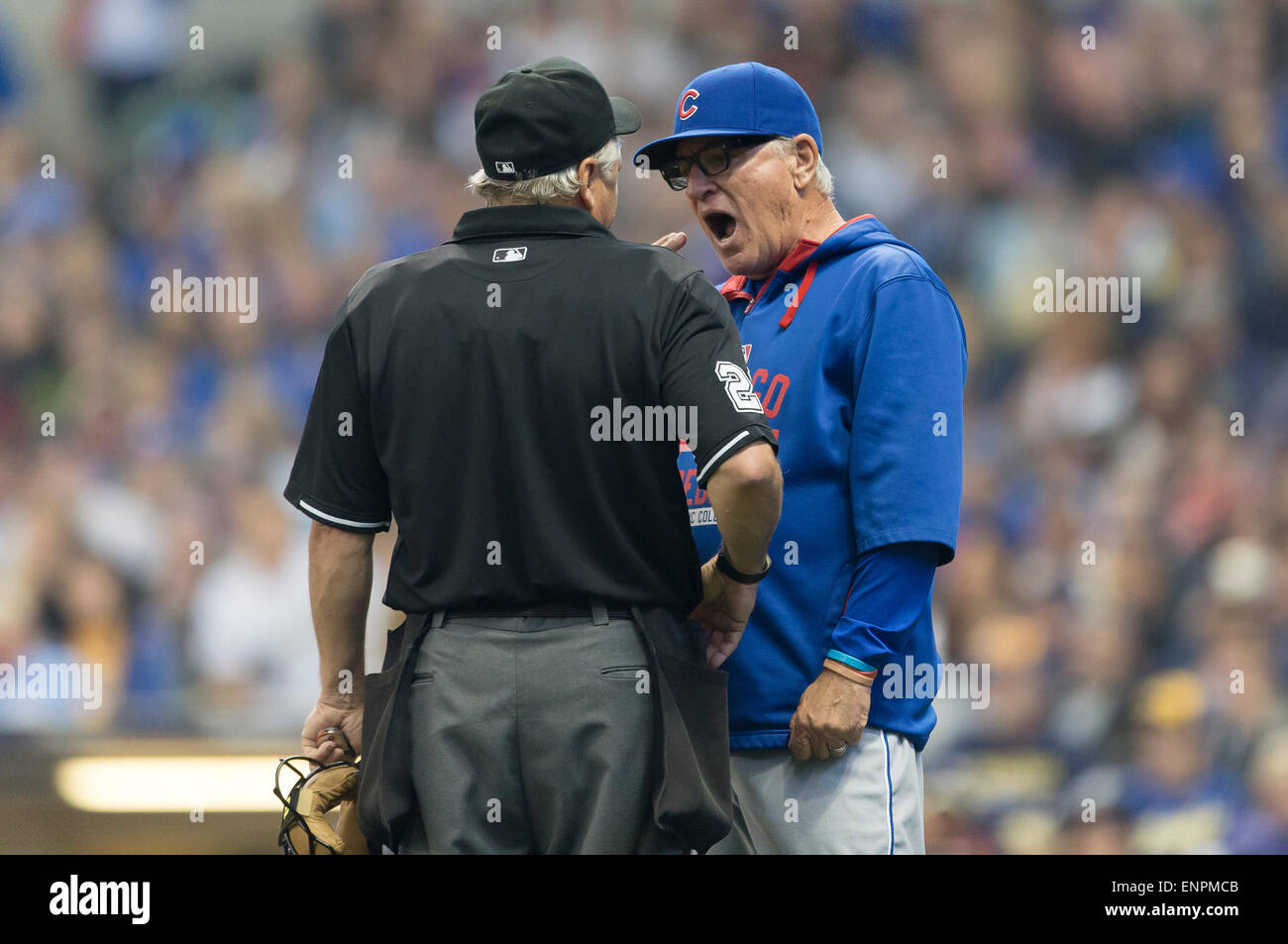 Milwaukee, WI, USA. 9th May, 2015. Chicago Cubs manager Joe Maddon #70 talks with home plate umpire Tom Hallion about a ball that was called trapped at the bottom of the outfield fence during the Major League Baseball game between the Milwaukee Brewers and the Chicago Cubs at Miller Park in Milwaukee, WI. John Fisher/CSM/Alamy Live News Stock Photo