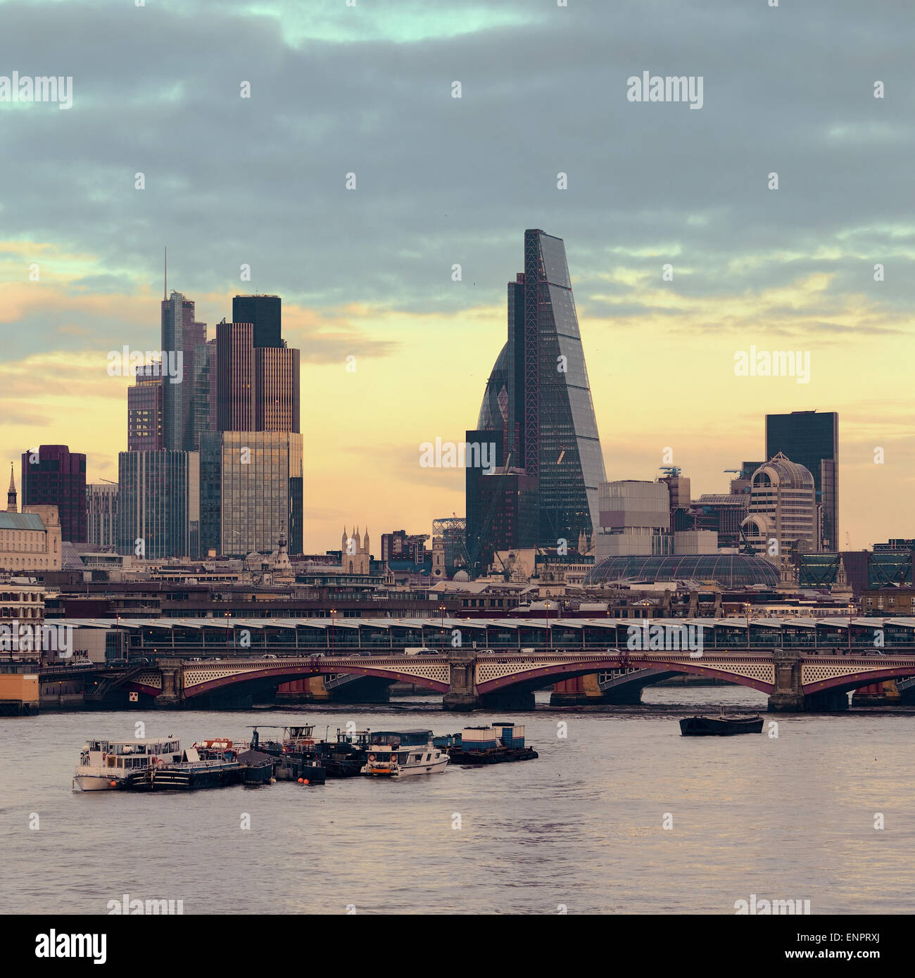 London cityscape at sunset with urban buildings over Thames River Stock Photo