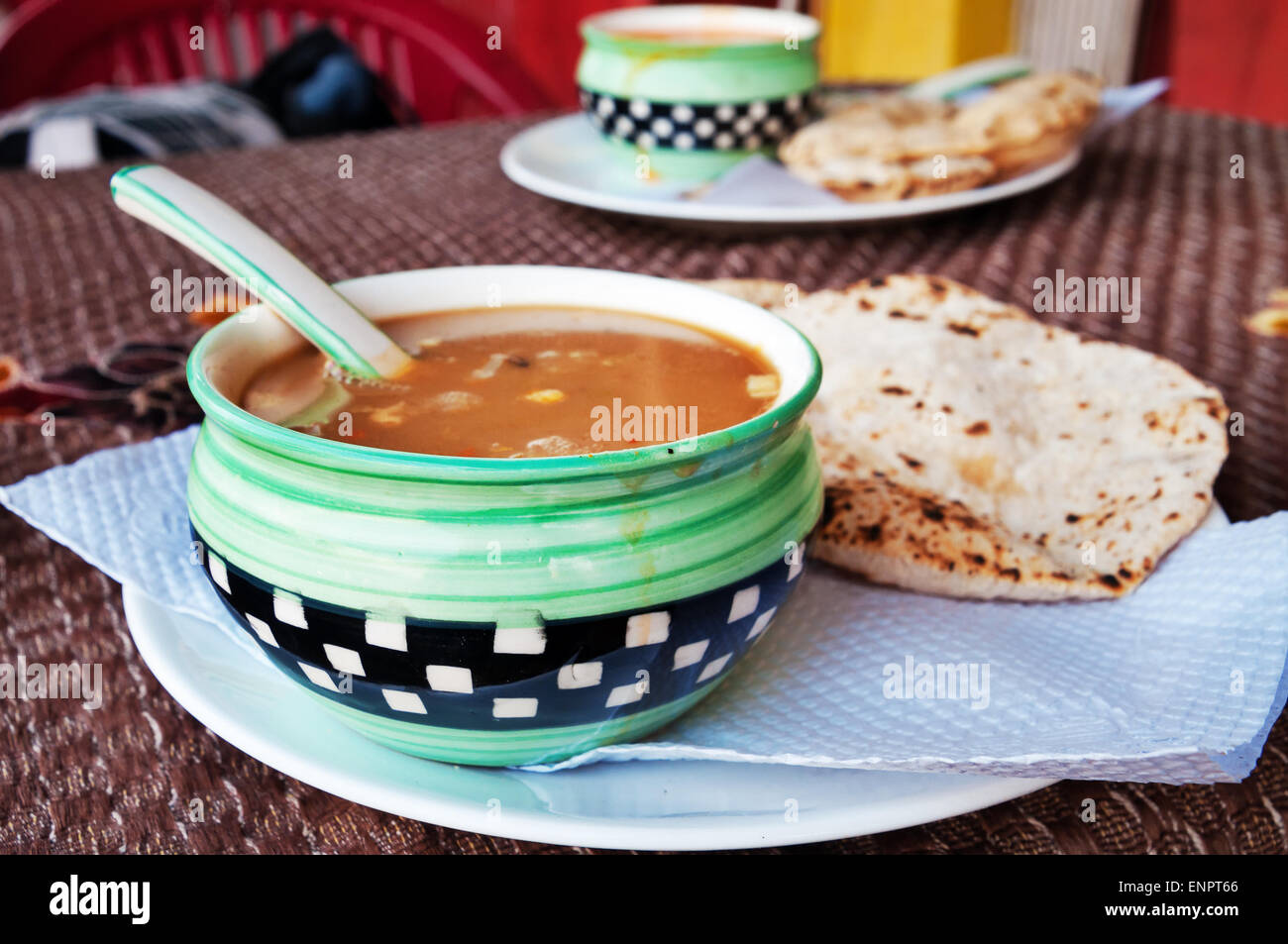 Indian tomato soup with chapati in Indian street restaurant Stock Photo