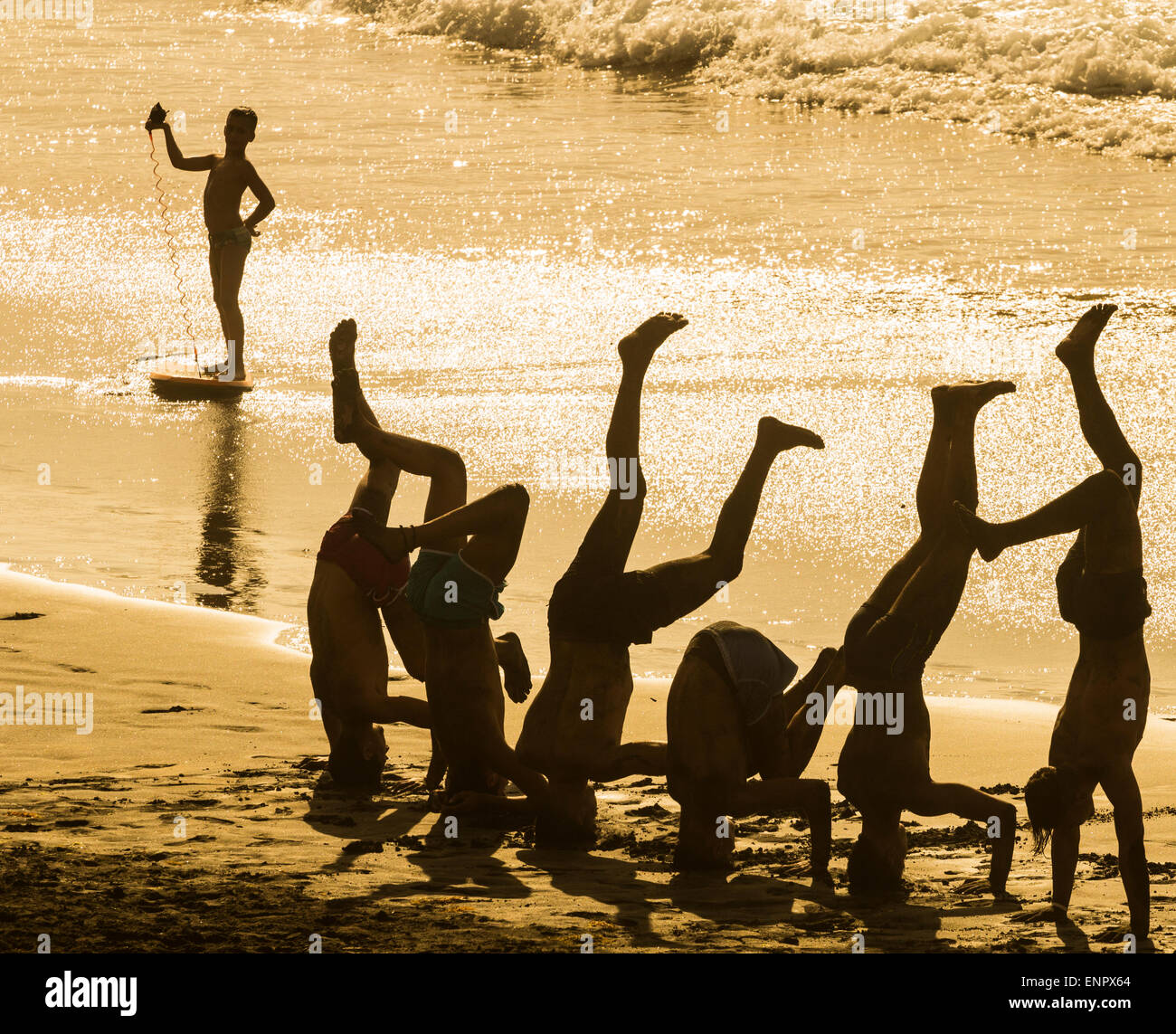 Spanish teenagers on Playa de Las Canteras beach at sunset. Las Palmas, Gran Canaria, Canary Islands, Spain. Stock Photo