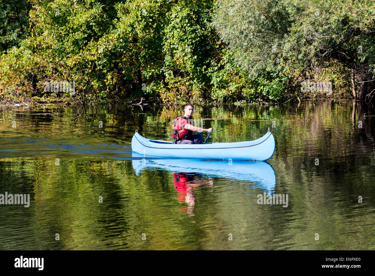 Young man in canoe Stock Photo - Alamy