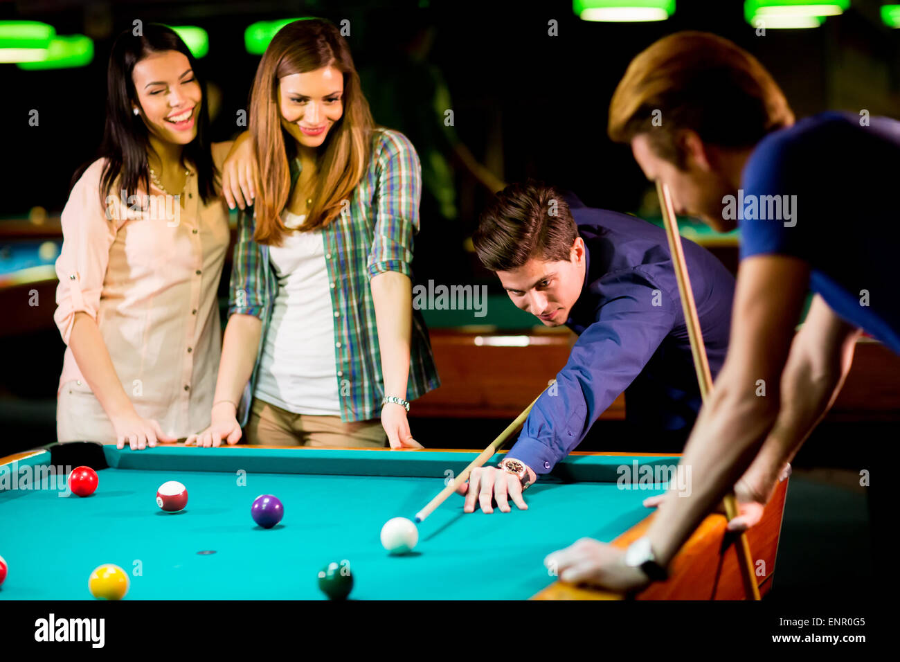 Young people playing pool Stock Photo - Alamy