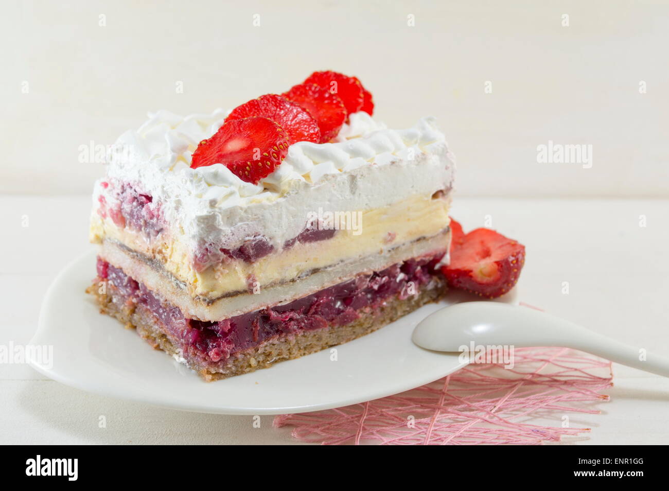 Homemade strawberry cake with whipped cream served on a plate Stock Photo