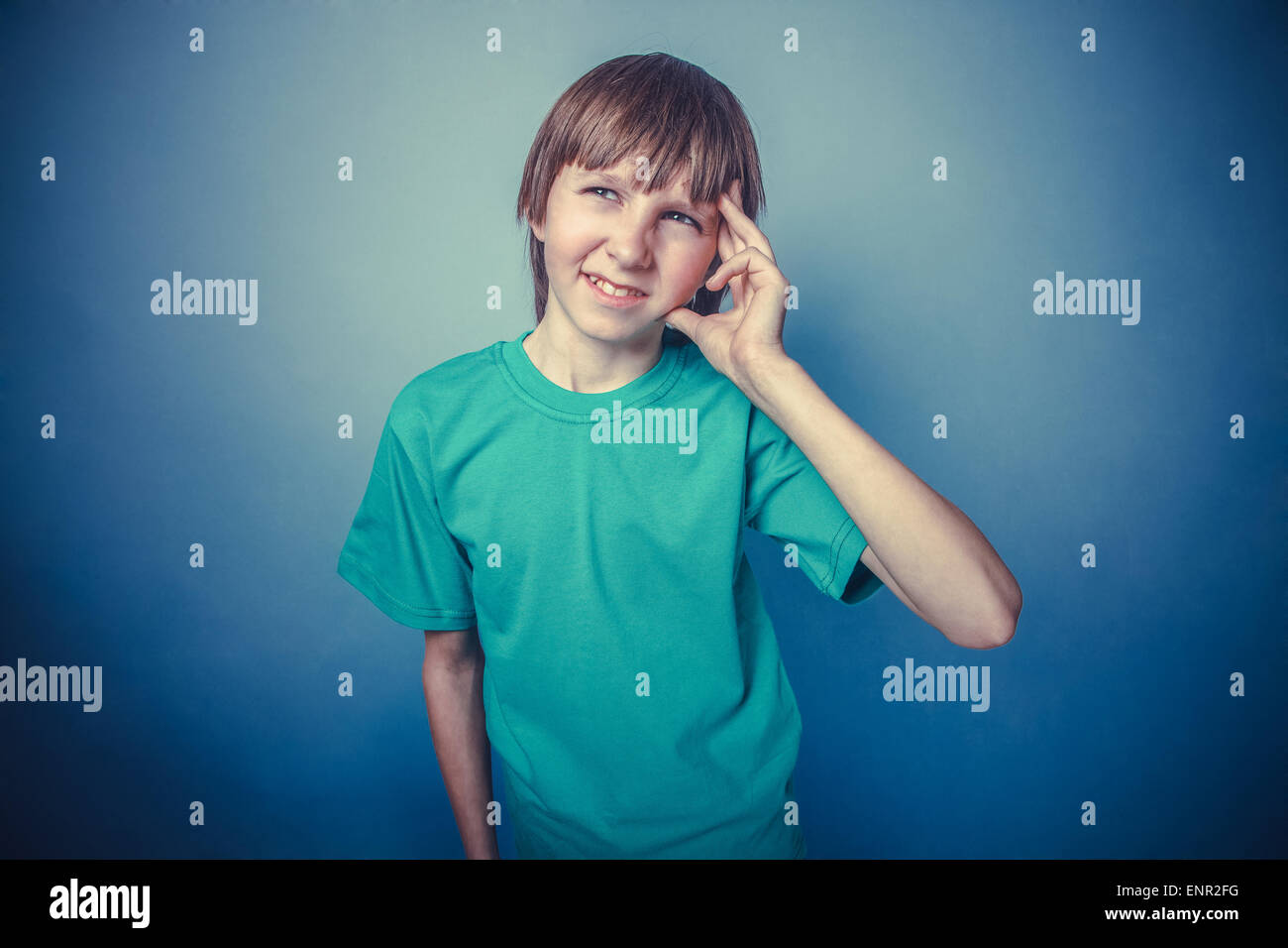 Boy, teenager, twelve years old, a in green tshirt holding temple a, a