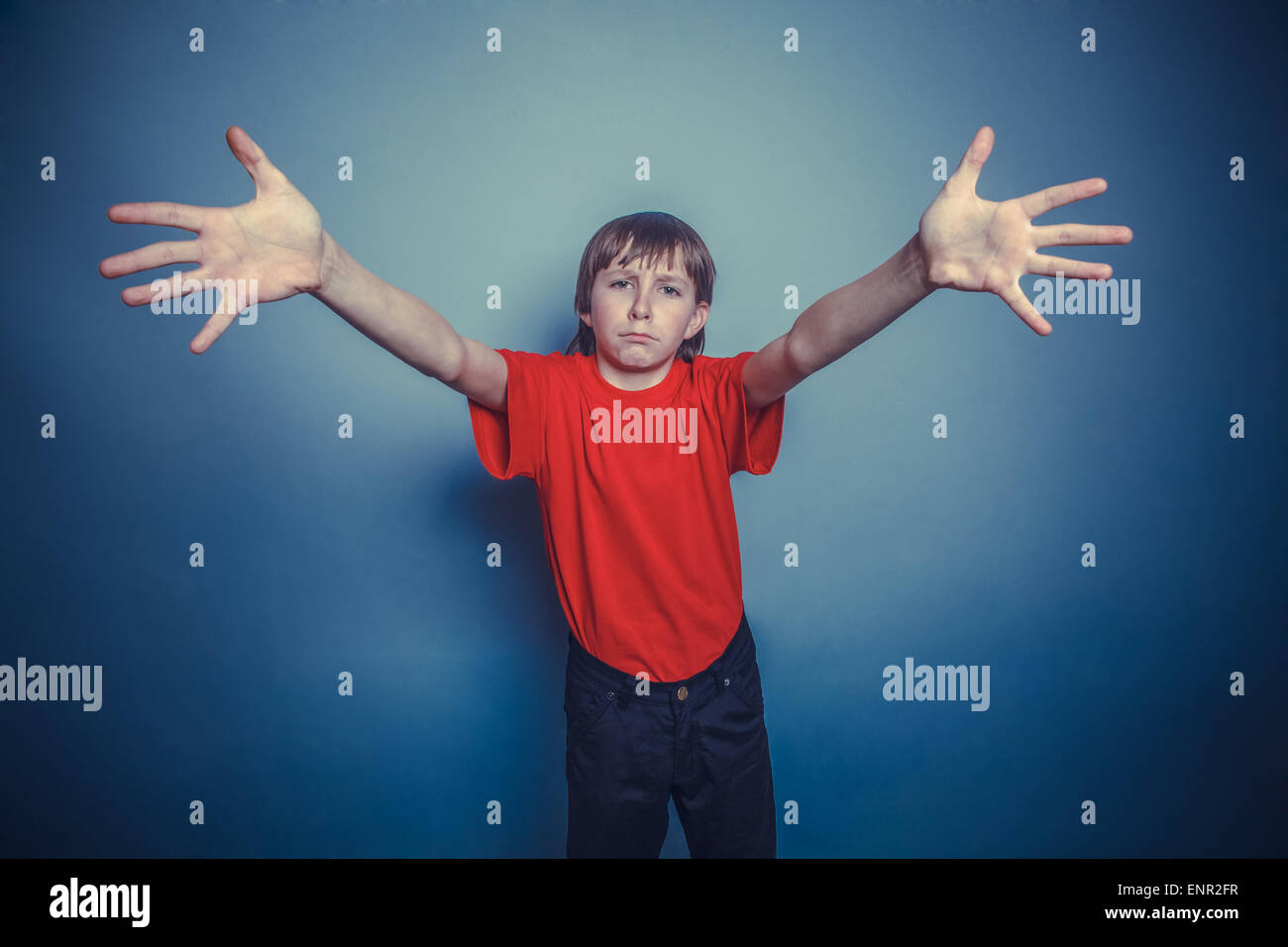 boy, teenager, twelve years old, a in red shirt, stretched his arms