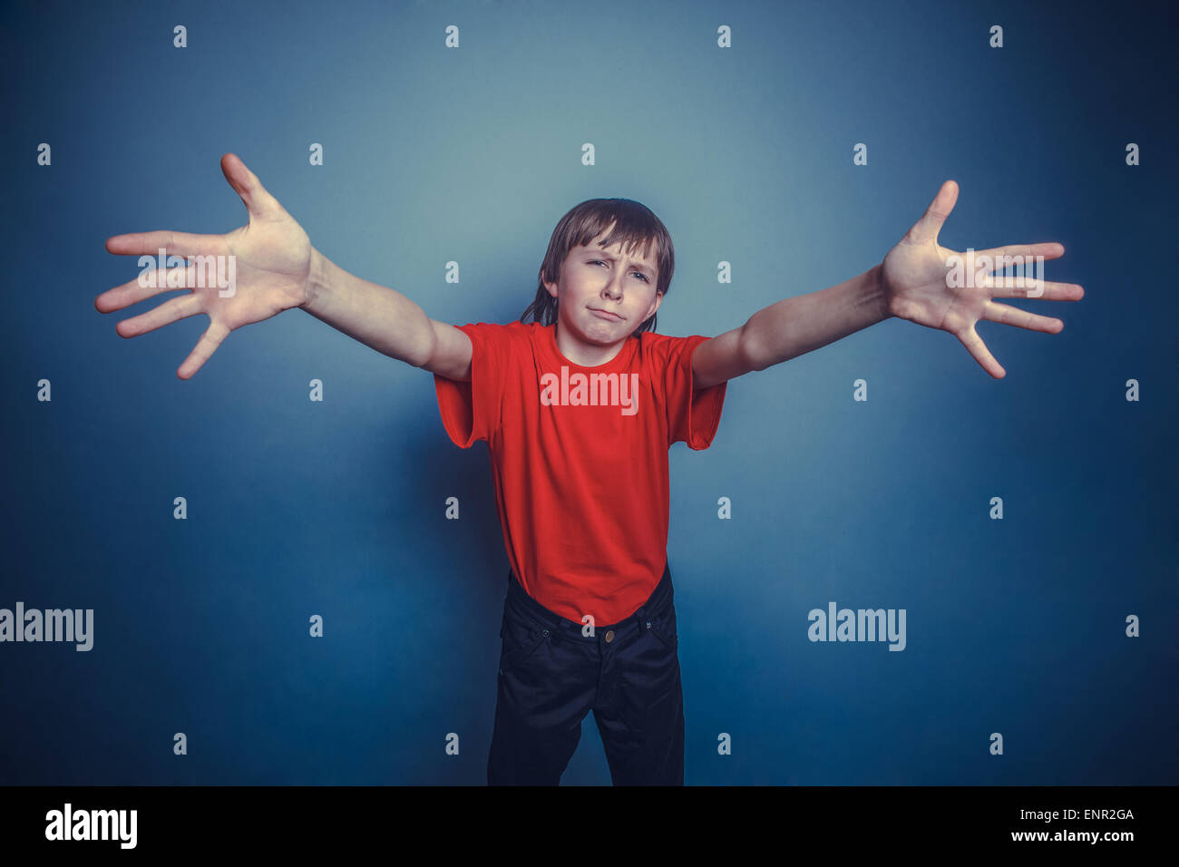 boy, teenager, twelve years old, wearing a red shirt, stretched forward