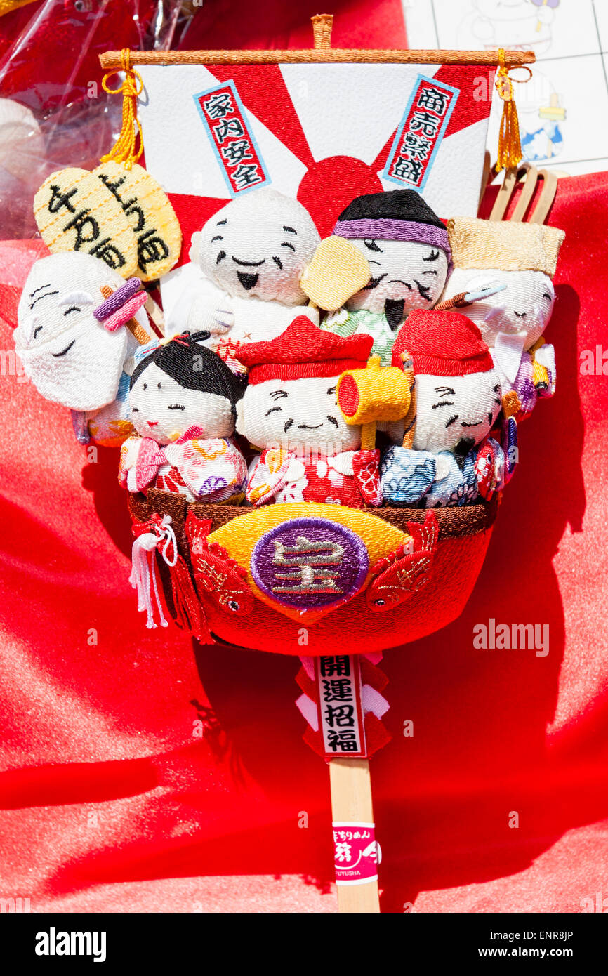 Japan. Japanese cloth shichifukijin, the seven Deities of good fortune in a takarabune, a ship laden with treasure. Often seen at shinto shrines. Stock Photo