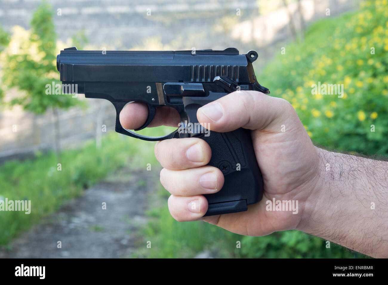 Detail of mans hand holding automatic pistol Stock Photo