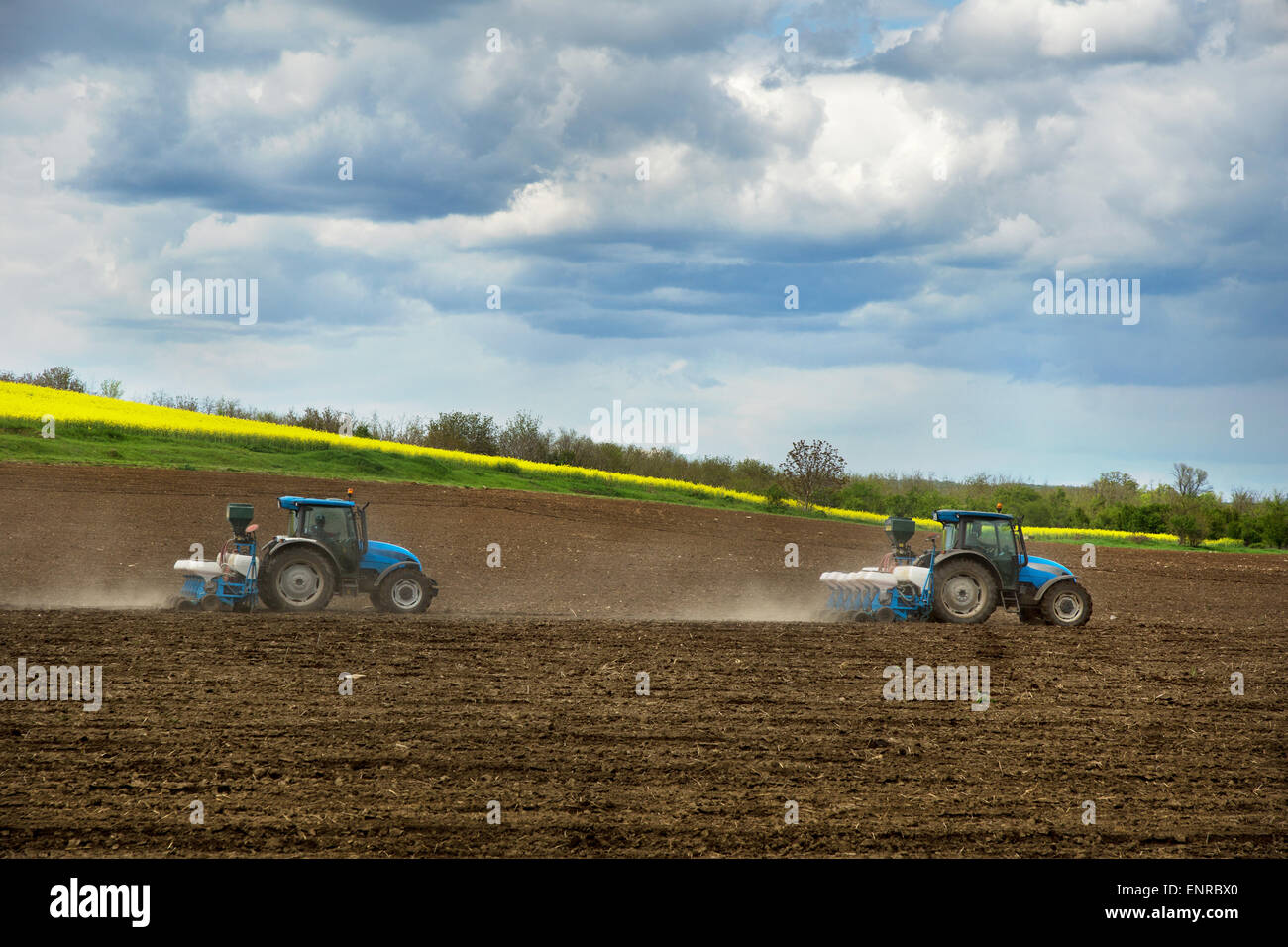Farming a field with a tractors Stock Photo Alamy