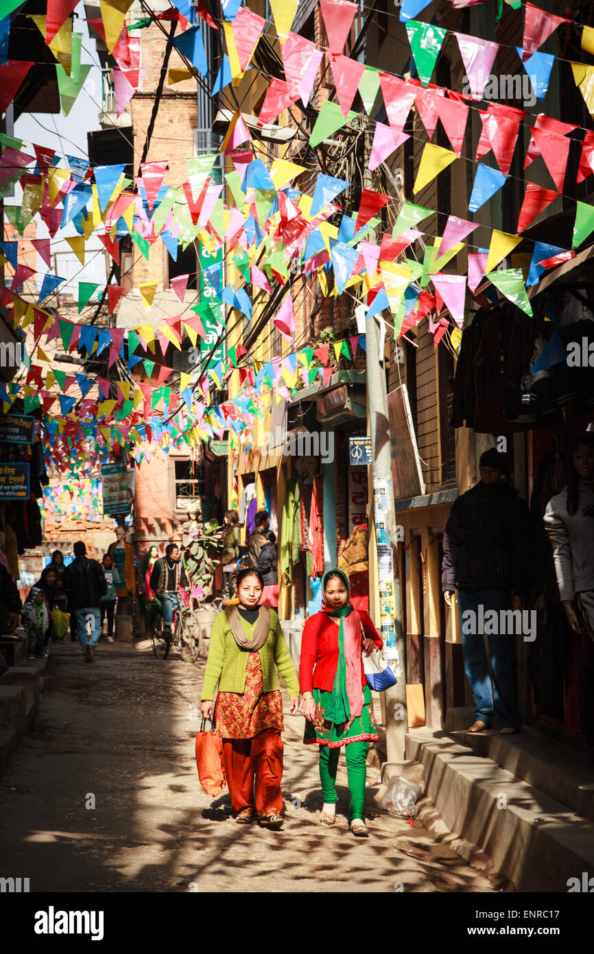Women in traditional clothing walking on colourful streets of Patan, Kathmandu, Nepal Stock Photo