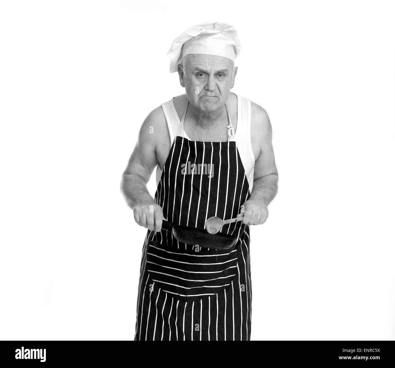 Grumpy foul tempered man as a low grade chef or cook in a greasy spoon Cafe, Stock Photo