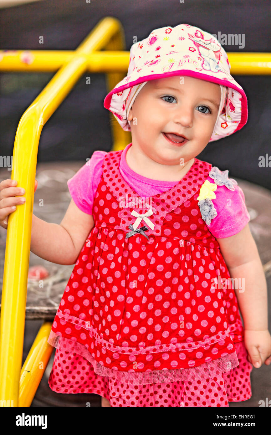 A pretty little girl with white hat having fun Stock Photo