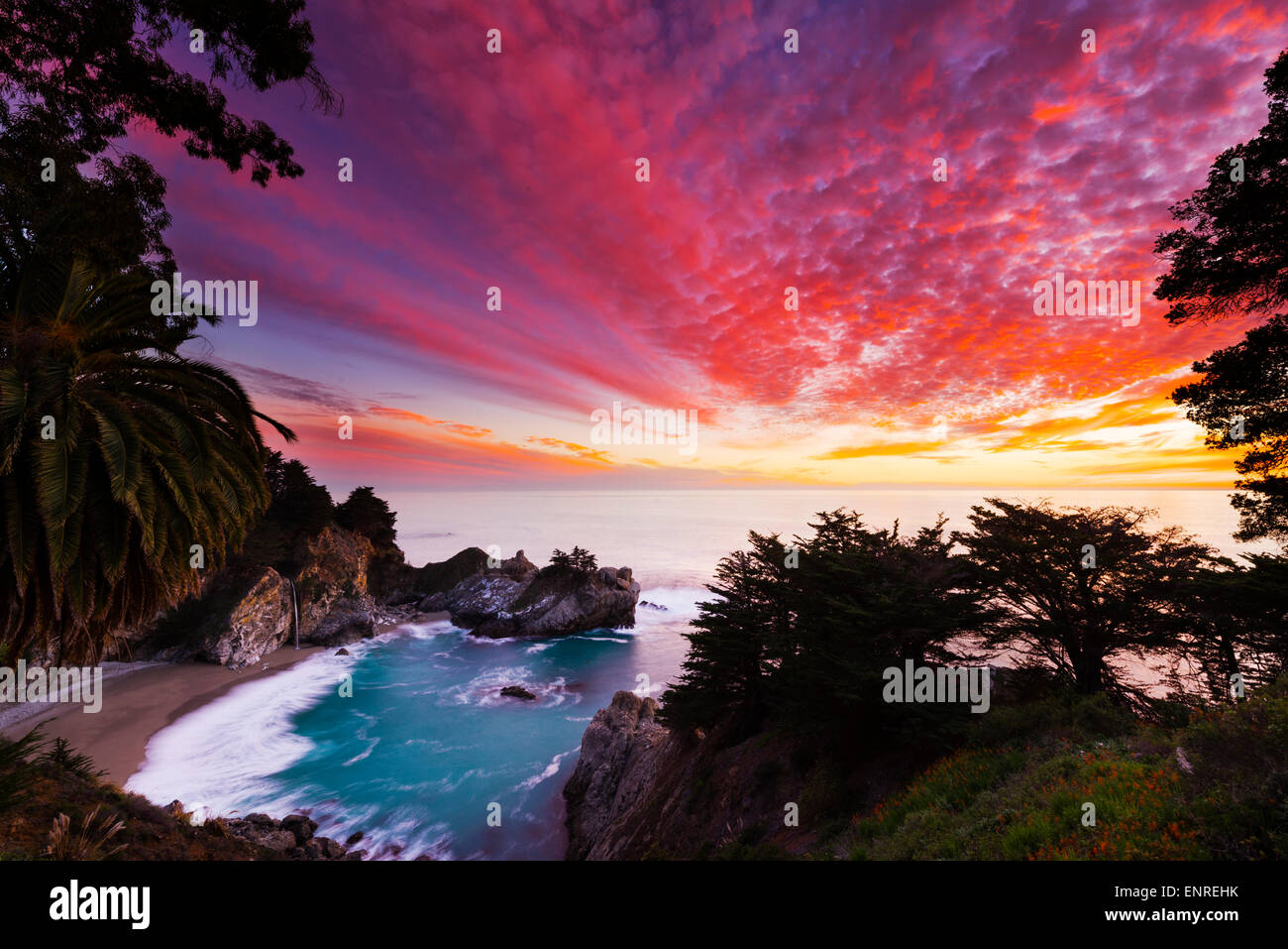 Beautiful sunset of McWay Falls into the Pacific Ocean along the Big Sur Coast of California just north of the Esalen Institute. Stock Photo