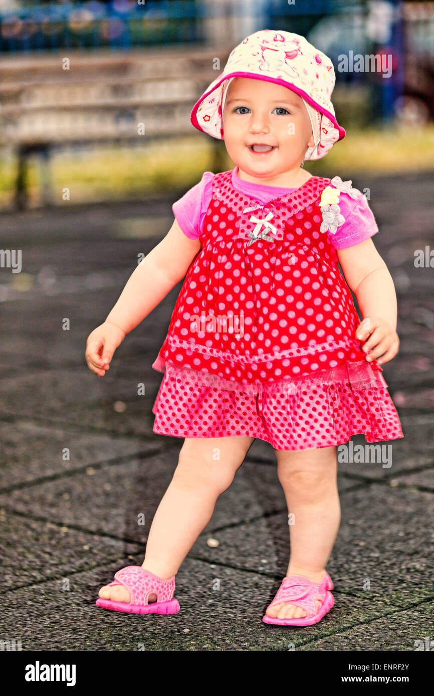 A pretty little girl with white hat having fun Stock Photo