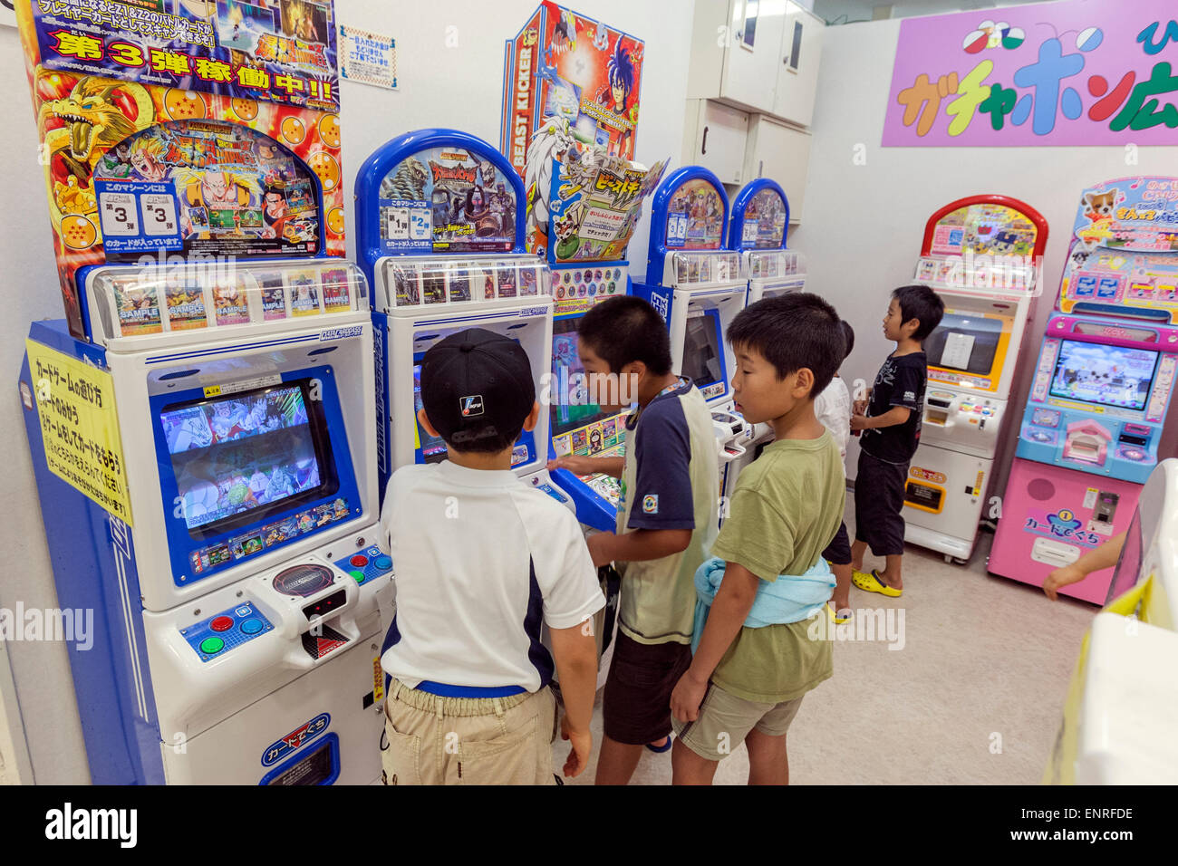 Young Japanese boys playing in game machine Stock Photo