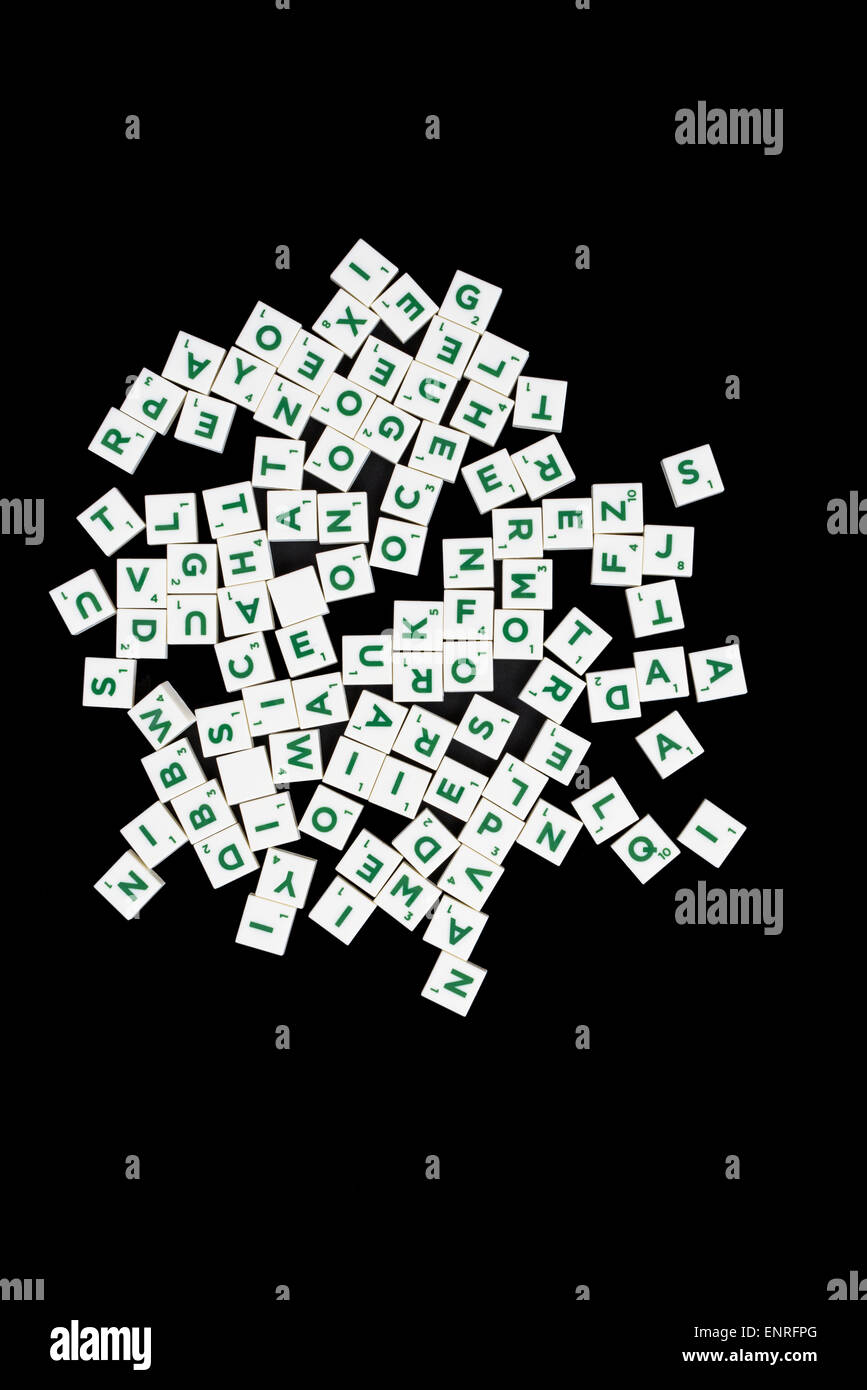 Portrait image of white word game tiles with green lettering on a black background Stock Photo