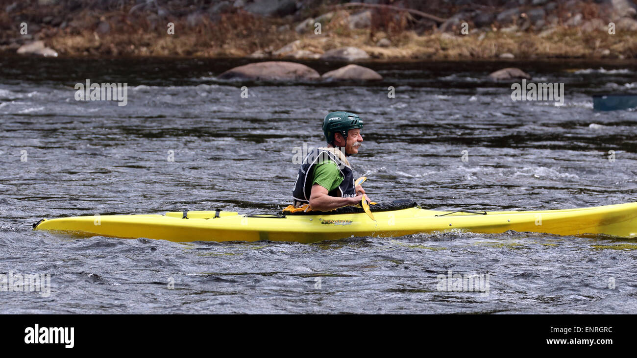 Senior man male in a yellow kayak. Kayaking on the Hudson River USA America Adirondack State Park Adirondacks. Stock Photo