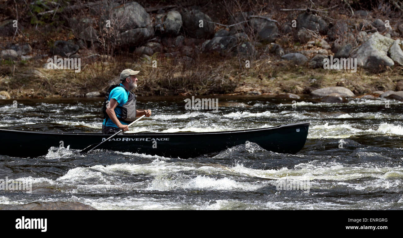 Senior man in a canoe shooting the rapids on the Hudson River New York. Adirondack State Park. Stock Photo