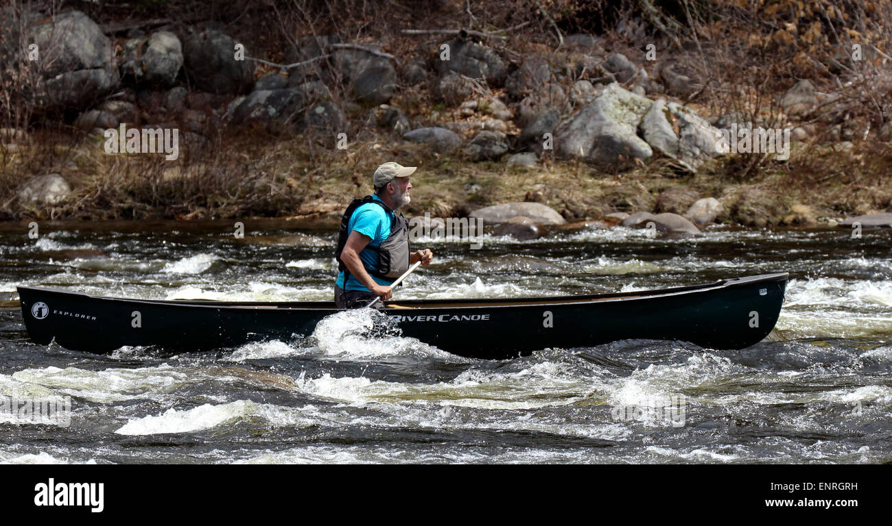 Senior man in a canoe shooting the rapids on the Hudson River New York. Adirondack State Park. Stock Photo