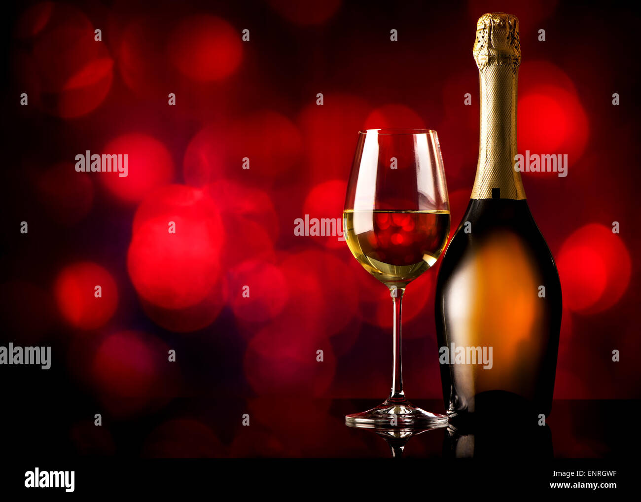 Bottle and glass of white wine on a red background Stock Photo