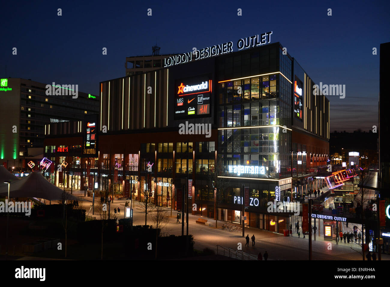 London Designer Outlet at Wembley Park Boulevard illuminated shops at night  Stock Photo - Alamy