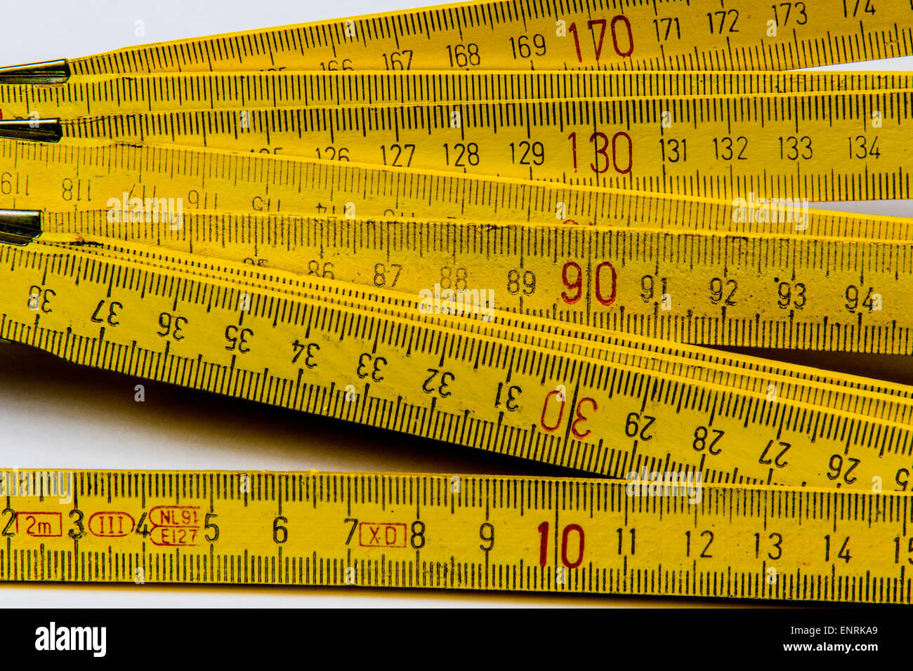 Yellow wooden folding ruler on white background Stock Photo