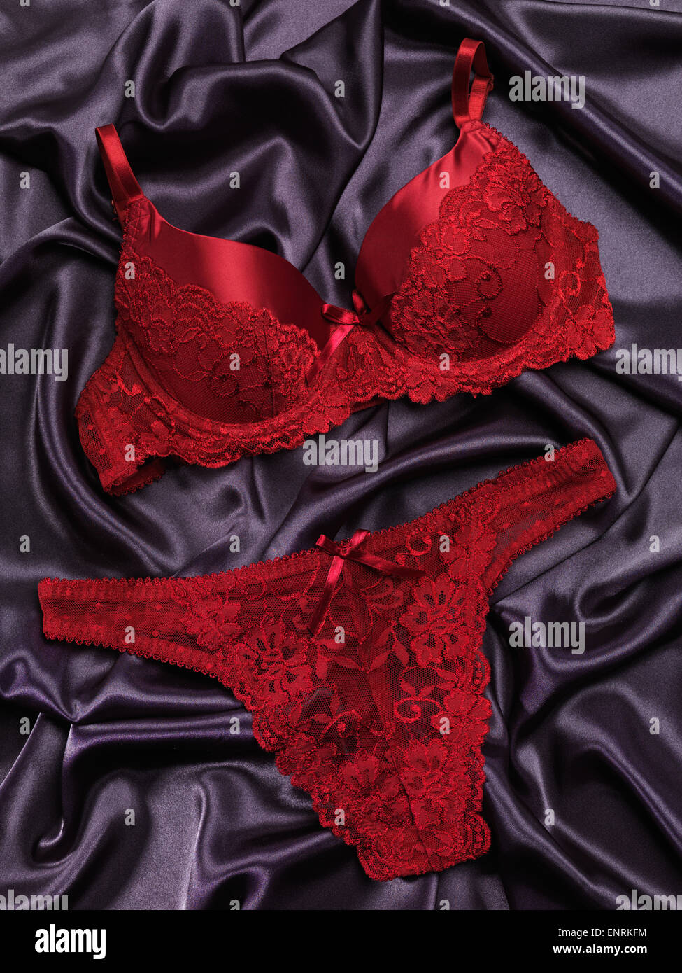 Red lacy lingerie womens underwear on black background Stock Photo