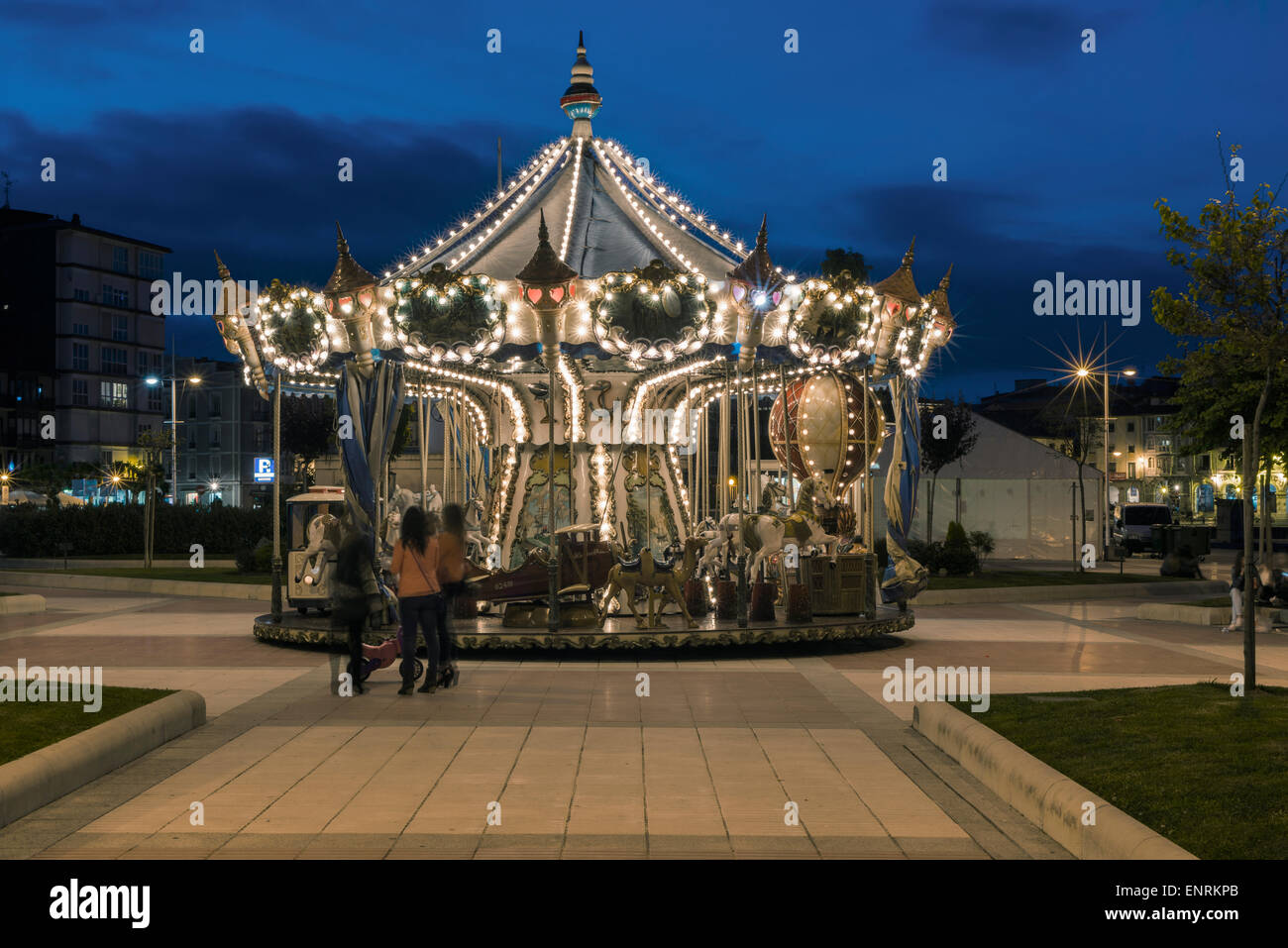 Carousel in motion at night in Castro Urdiales. Cantabria, Spain. Stock Photo