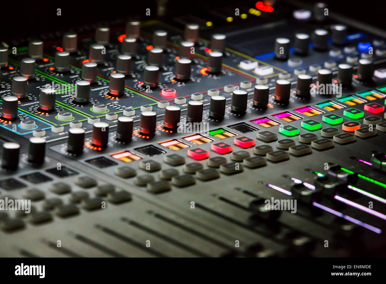 Audio mixer mixing board fader and knobs with selective focus central buttons, Music mixing console with backlit buttons Stock Photo - Alamy