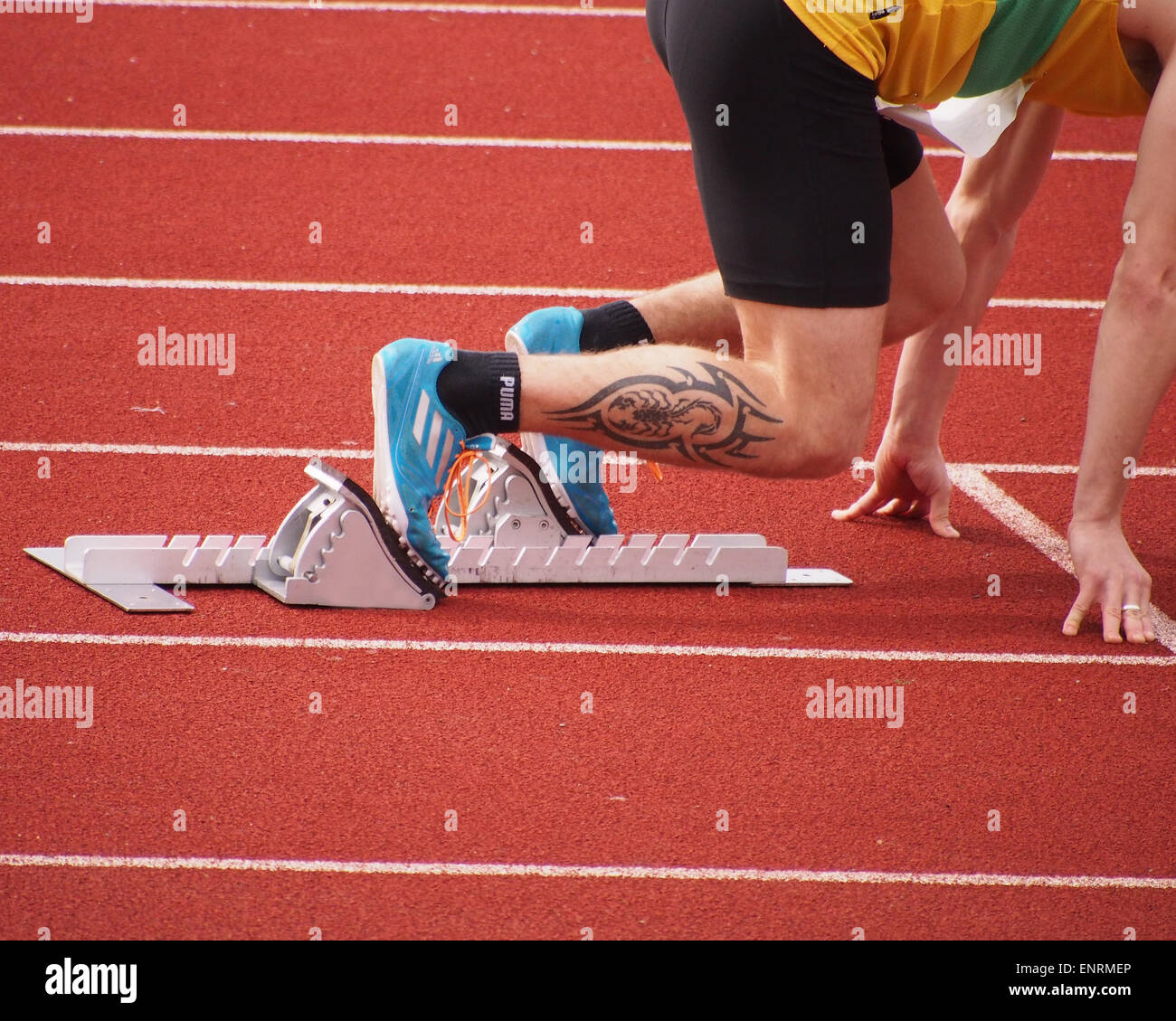 An Athletes feet placed firlmy onto starting blocks, ready to start a race Stock Photo