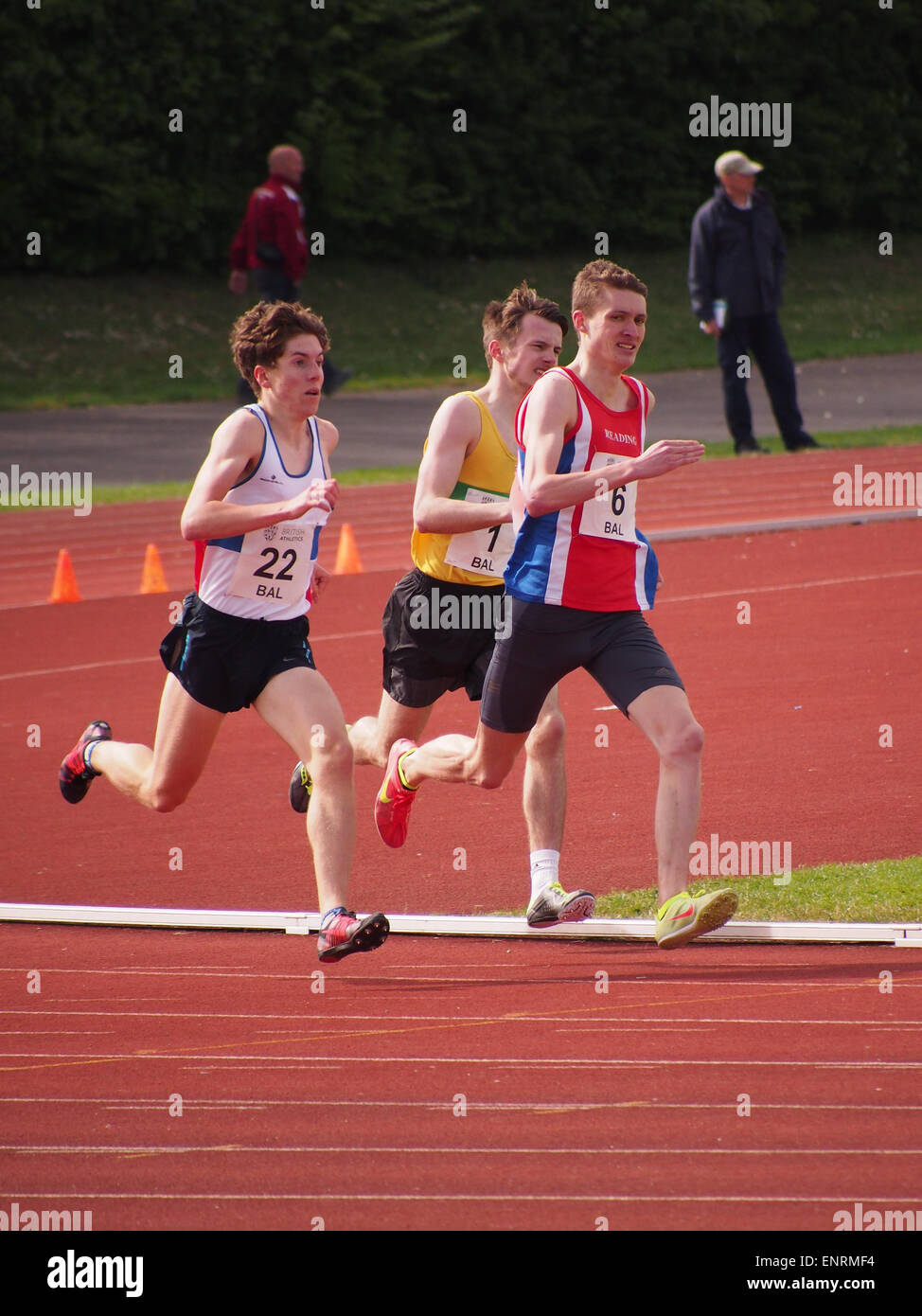 Athletes race on a running track Stock Photo