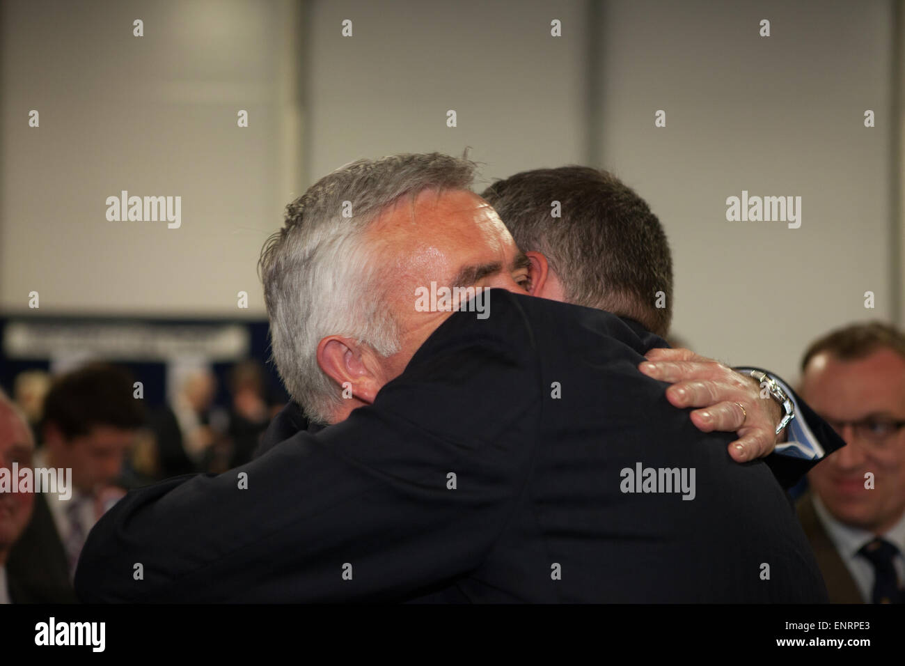 Belfast UK. 7th May 2015 General Election:  Jonathan Bell hugs Gavin Robinson from the Democratic Unionist Party (DUP) after win Stock Photo