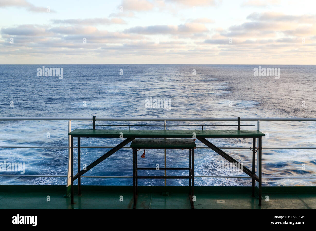 Freighter travel: empty table and trace of cargo ship in the open sea of the Atlantic ocean Stock Photo