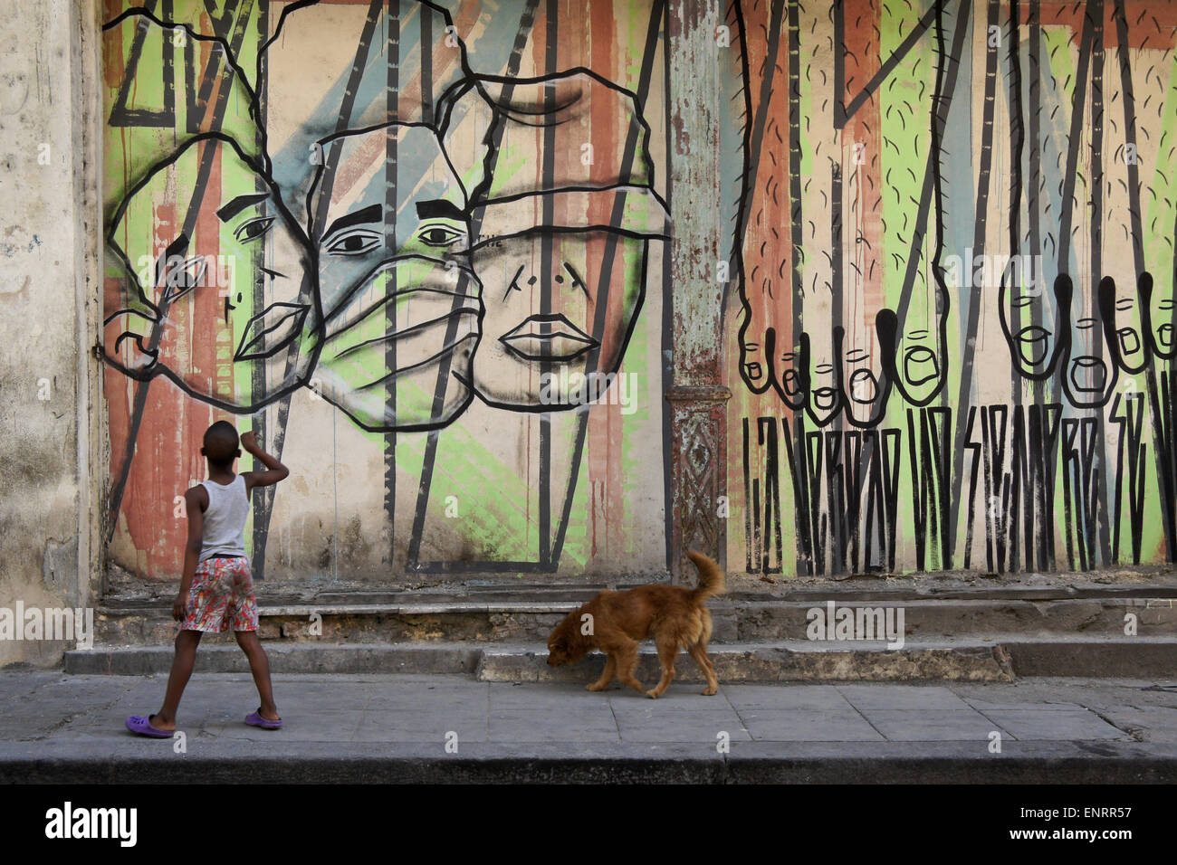 Boy, dog, and street mural, Havana, Cuba Stock Photo