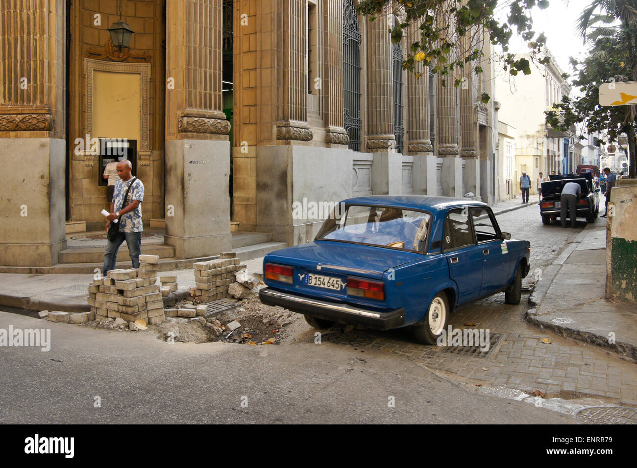 Old Russian car (Lada) negotiating potholed street, Habana Vieja (Old Havana), Cuba Stock Photo