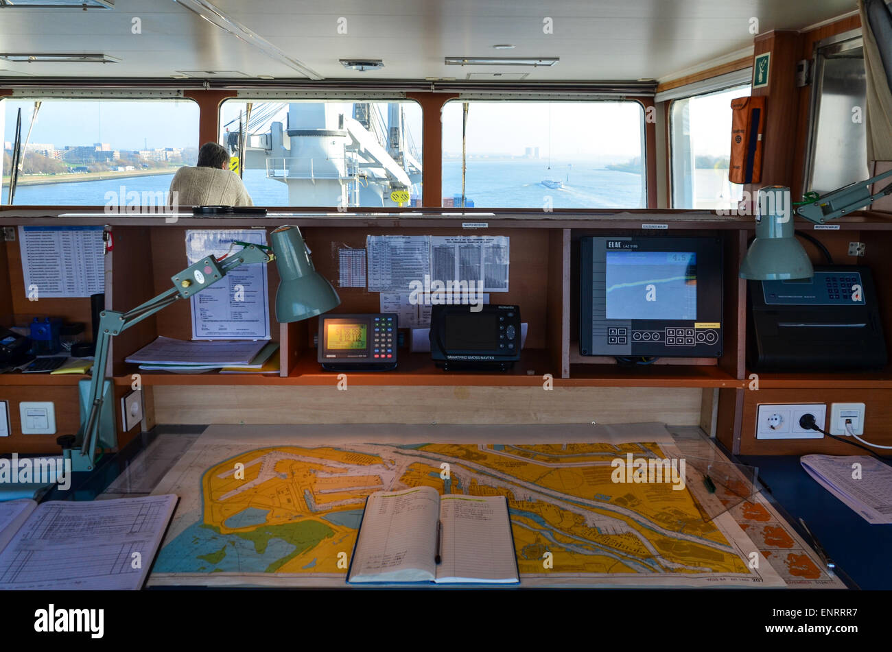 Nautical charts in the ship bridge of a cargo vessel while sailing into the port of Rotterdam Stock Photo