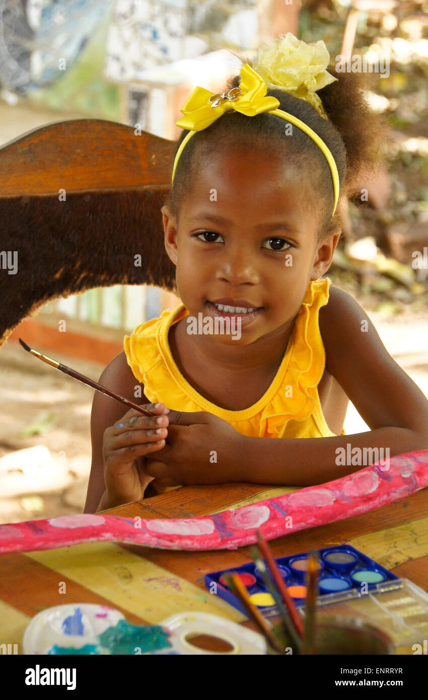 Little girl working on art project (painted seed pod), Pinar del Rio, Cuba Stock Photo