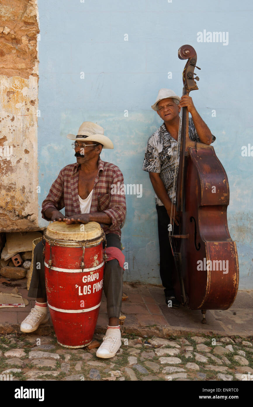 Two men making music on cobblestone street, Trinidad, Cuba Stock Photo