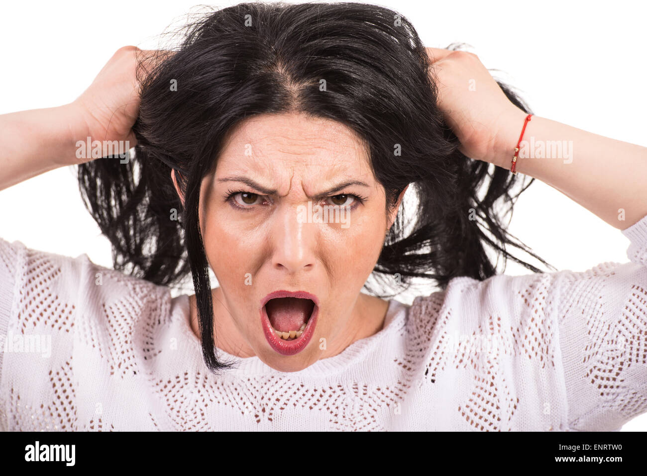 Nervous woman yelling and pull  her hair isolated on white background Stock Photo