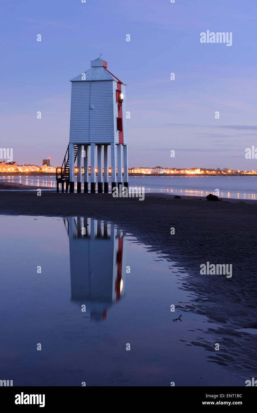 The wooden lighthouse alight at dusk on Burnham-on-Sea Beach, Somerset. Stock Photo