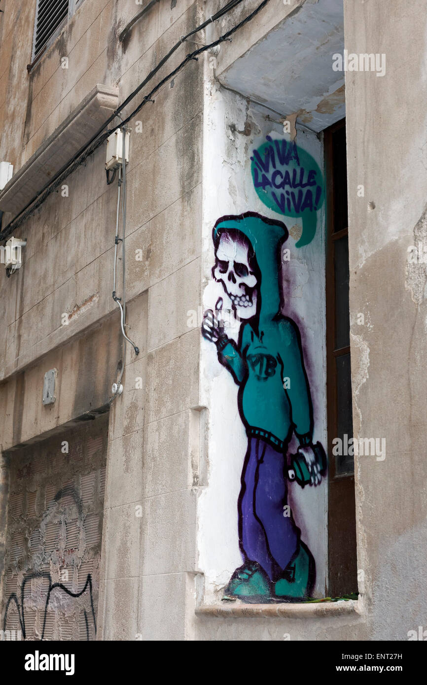 Sprayer with skull-face, hooded sweatshirt, mural, street art, Palma de Majorca, Majorca, Balearic Islands, Spain Stock Photo
