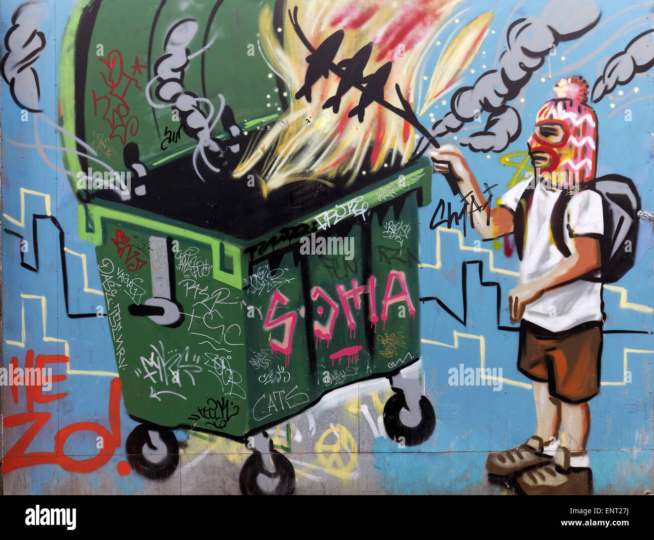 Man with facemask grilling fish over a fire in a dumpster, mural, street art, Palma de Majorca, Majorca, Balearic Islands, Spain Stock Photo