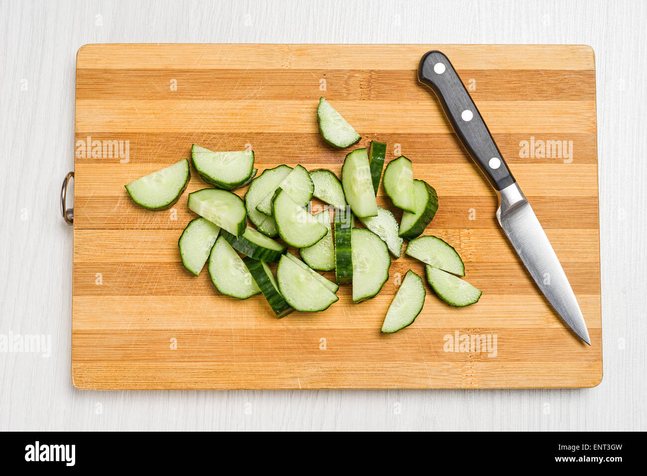 Board for cutting vegetables, a knife and cucumbers with tomatoes Stock ...