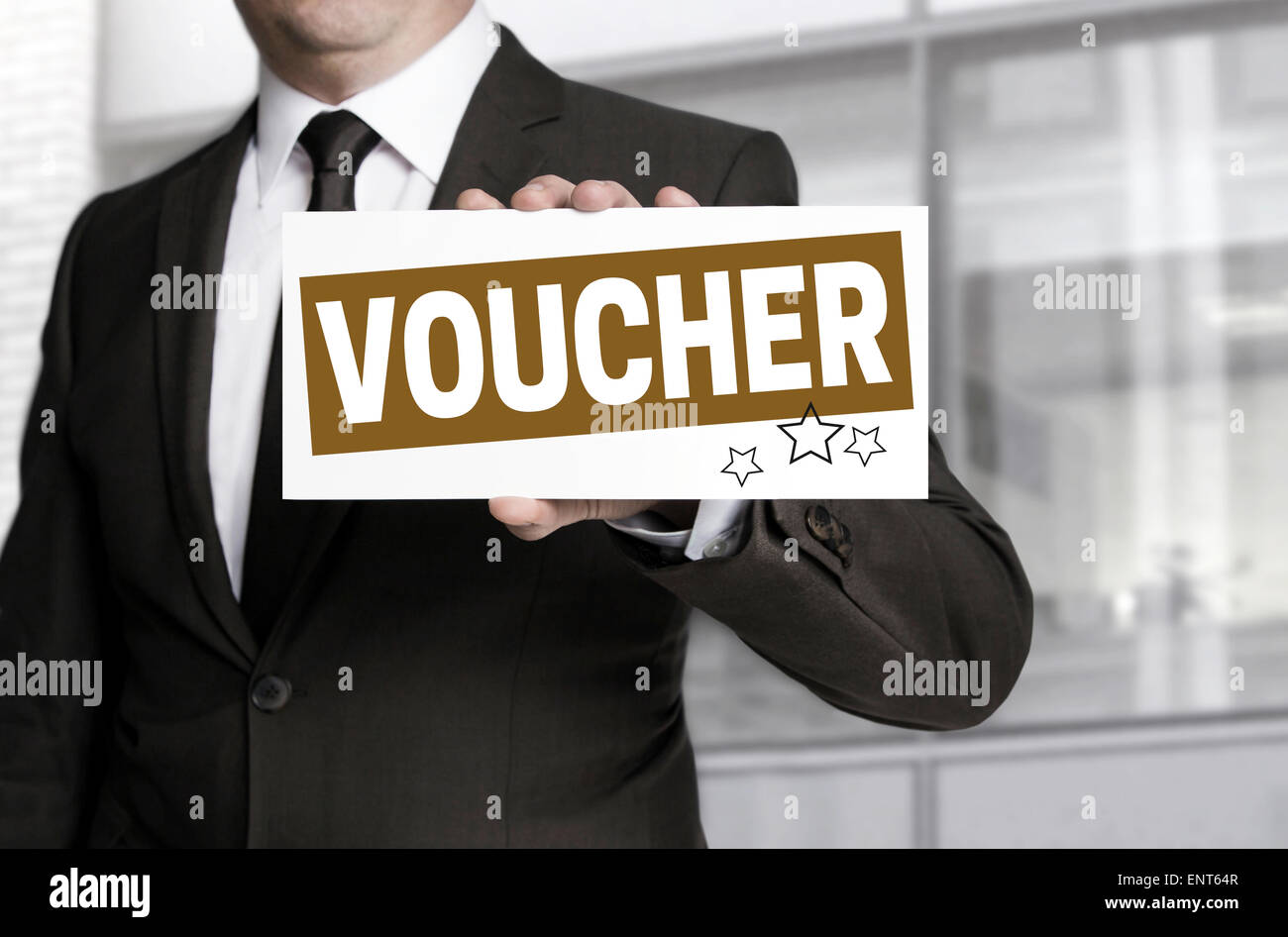 Businessman holding sign voucher to viewer. Stock Photo