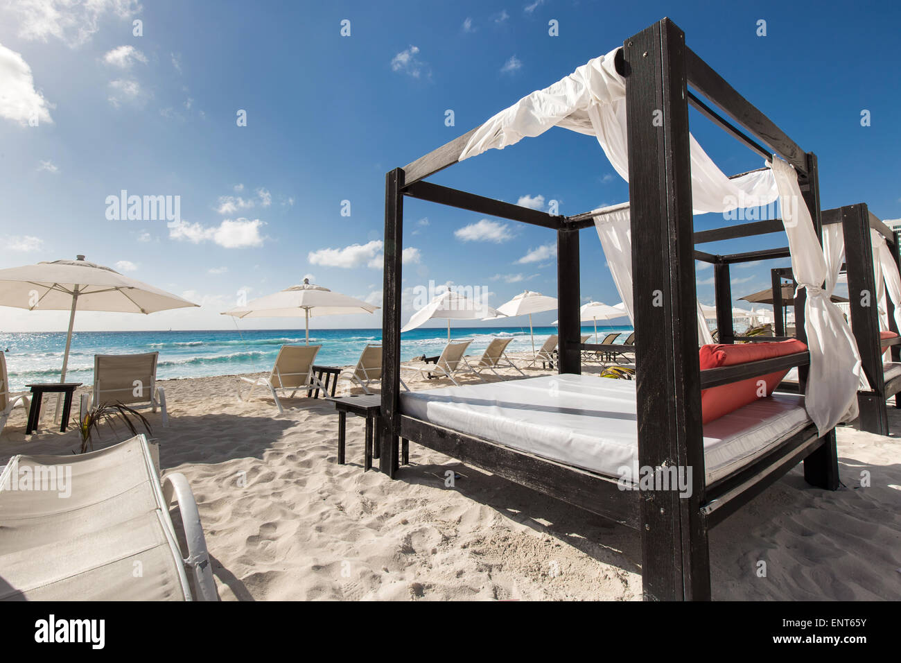 Luxury wooden lounge beds on a beautiful caribbean beach Stock Photo