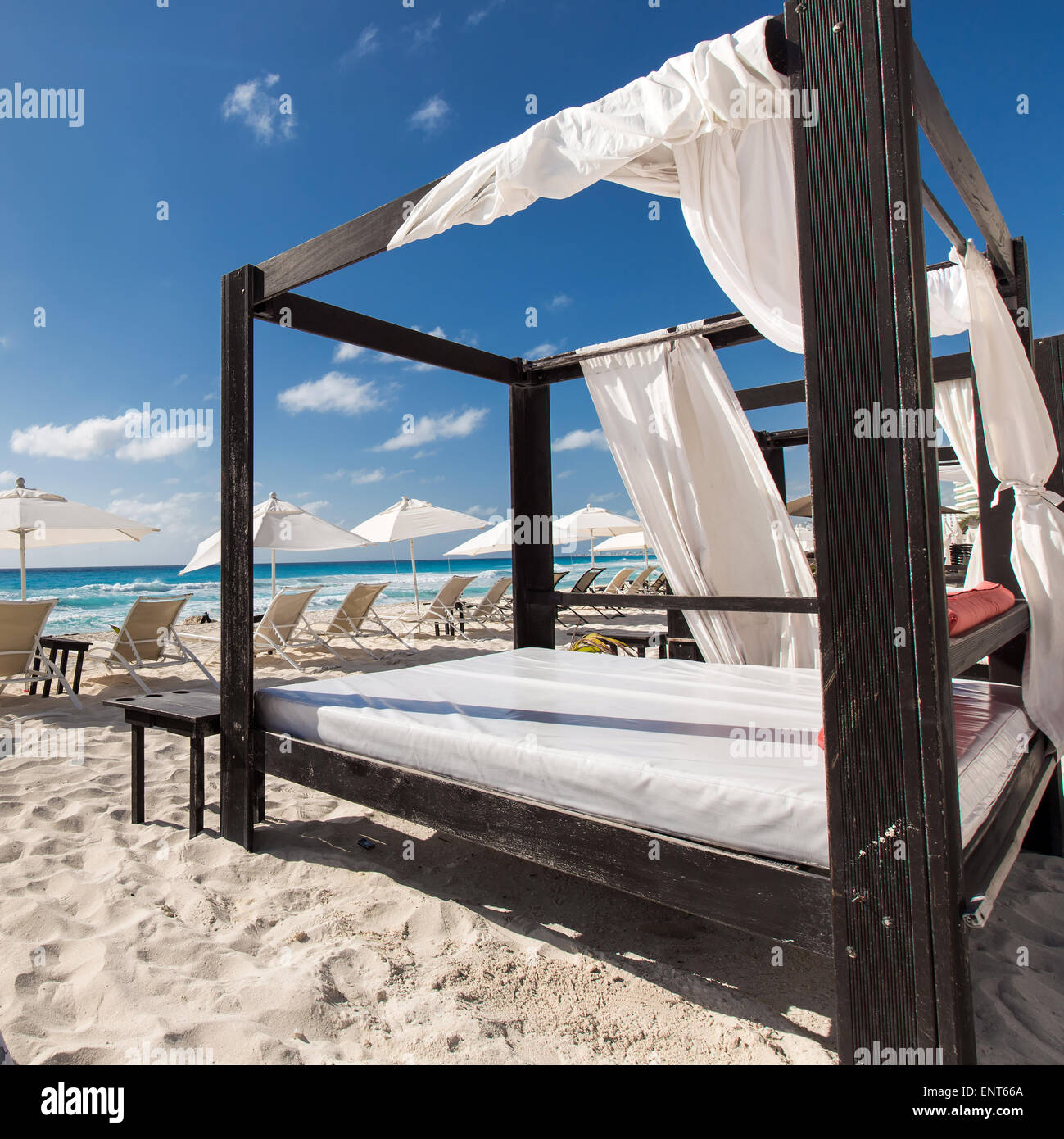 Luxury wooden lounge beds on a beautiful caribbean beach Stock Photo