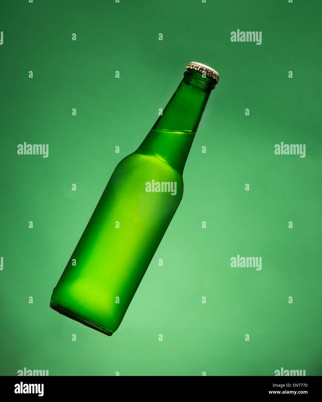 Green beer bottle in air. Stock Photo